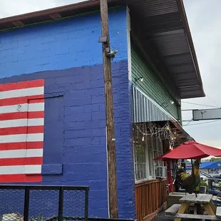 an american flag painted on the side of a building
