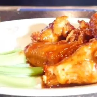 a plate of chicken wings and celery