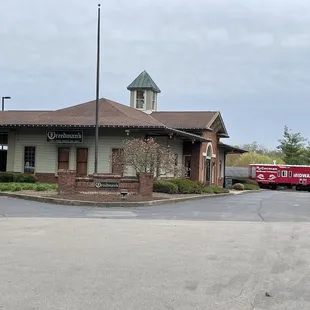 a red truck parked in front of a building