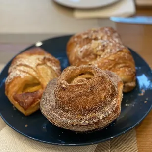 three pastries on a blue plate