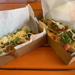 two hot dogs with toppings