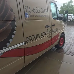 a brown box bakery van parked in a parking lot