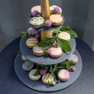 a three tiered cake with macarons