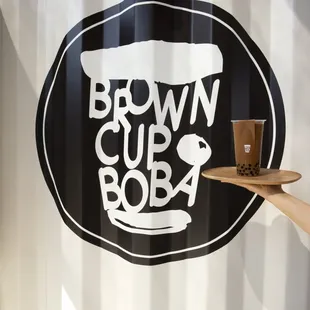 a woman holding a tray of coffee