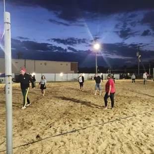 a group of people playing volleyball