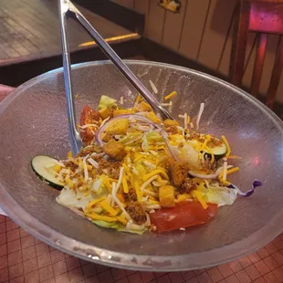 a bowl of food with chopsticks