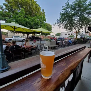 a glass of beer on a wooden table