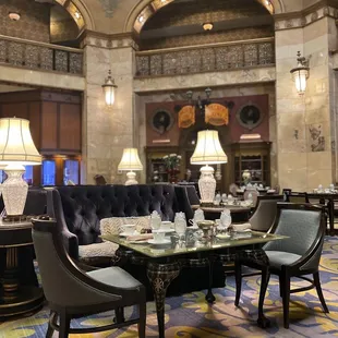a dining room with a glass table and chairs