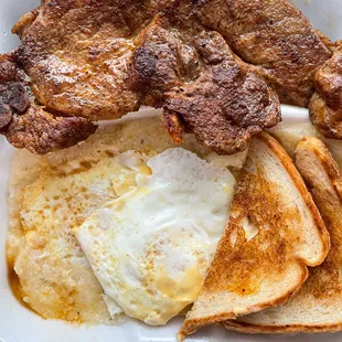 eggs, toast, and sausage in a styrofoam container
