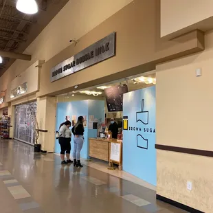 two people walking through a store