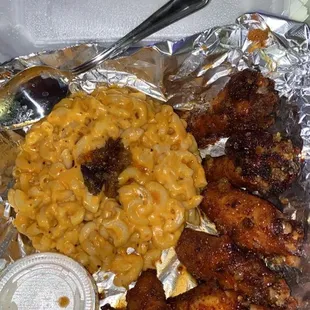 Spicy Garlic/Honey Glaze wings &amp; oxtail Mac ...soooo good! More oxtail is at the bottom, it was flipped out of the bowl it came in.