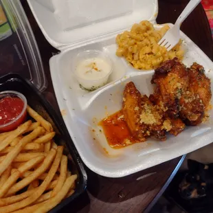 Spicy honey garlic wings with fries and a side of Mac n cheese