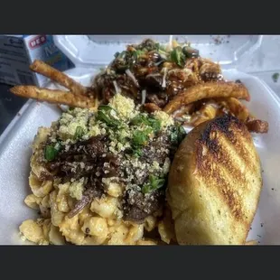 Oxtail Macaroni and Cheese with Smothered French Fry&apos;s and Garlic Toast. You will need to KETO later.