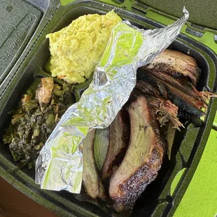 Ribs, sliced brisket, potato salad and collard greens