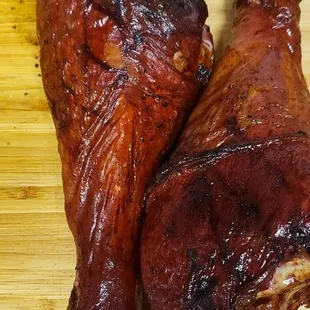 two pieces of meat on a cutting board