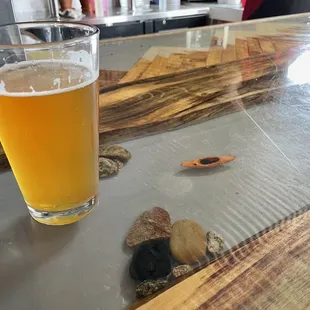 a glass of beer on a bar