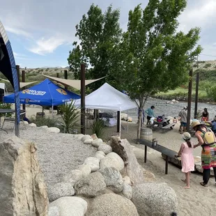 people enjoying a picnic on the banks of the river