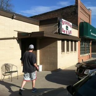 a man walking in front of a restaurant
