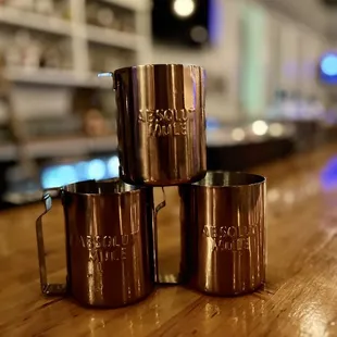 three copper mugs