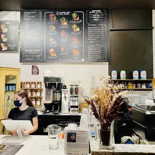 a woman working at a coffee shop