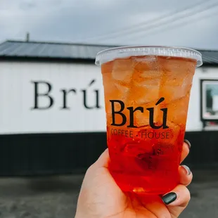 a person holding up a drink