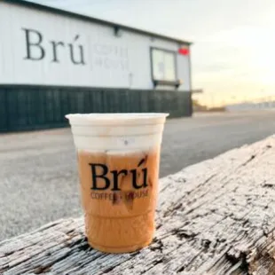 a cup of coffee on a bench