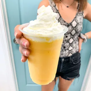 Mango pineapple smoothie with whipped cream