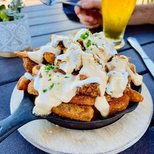 a plate of french fries and a glass of beer