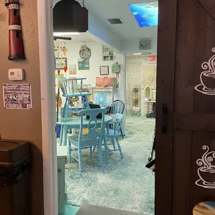 Walk through the coffee shop to a Shared business space with an arts and crafts boutique that features local artists work.