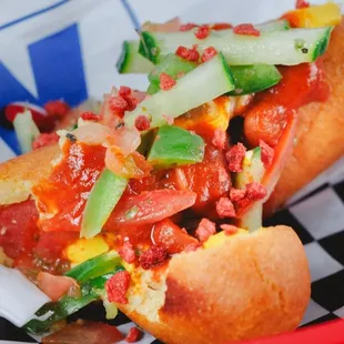 a hot dog with toppings in a basket