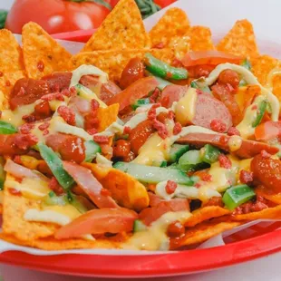 a plate of nachos with tomatoes and cheese