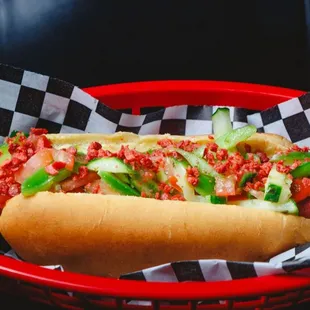 a hot dog with toppings in a basket