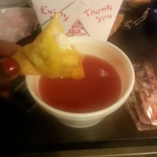 Crab Rangoon with sweet and sour sauce.