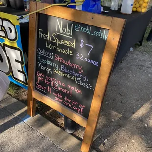 a chalkboard with a price list