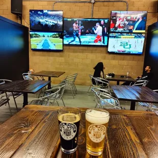 a beer and two televisions