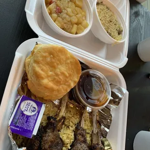 Lamb chops, seasoned rice. Comes with two sides. Potatoes and Rice were our choices. (Didn't know the chops came with rice.). Delicious!!