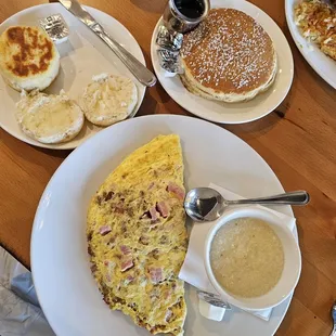 Omelet, biscuits, grits, and short stack of buttermilk pancakes