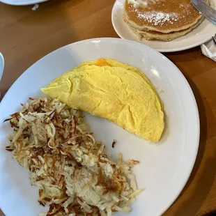 Cheese omelette comes with yummy pancakes and hash browns.