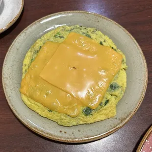 Scrambled eggs with cheese, green pepper, and spinach