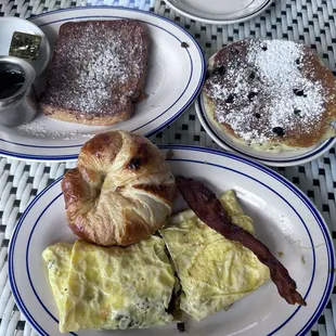 French toast, blueberry pancake and crab cake omelette with a slice of bacon