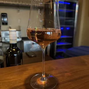 a glass of wine on a bar