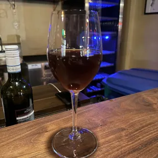 a glass of wine on a bar