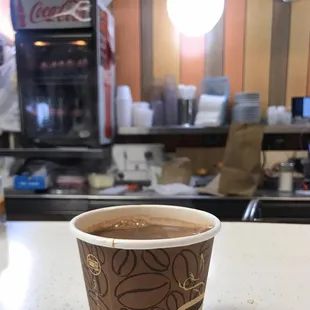 a cup of coffee on a counter