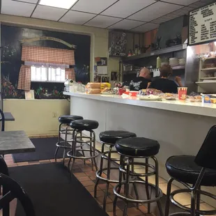 a restaurant with a counter and stools