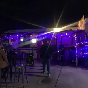 a man walking in front of the bar