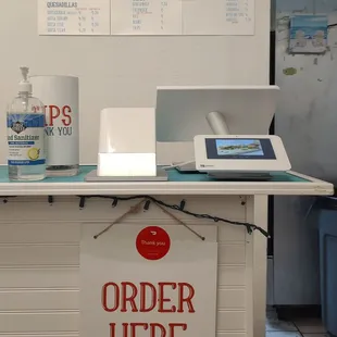 Service counter with menu sheets on the wall