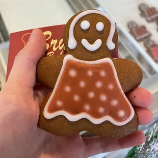 a hand holding a gingerbread man