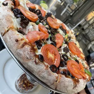 a pizza with tomatoes and olives