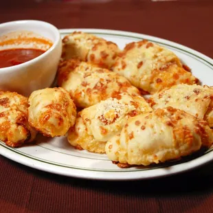 a plate of cheesy bread rolls