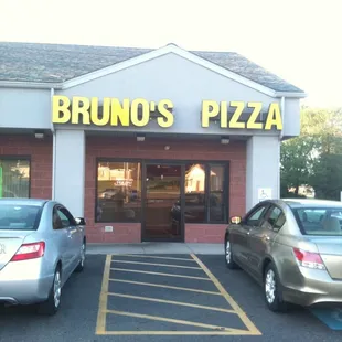 two cars parked in front of a restaurant